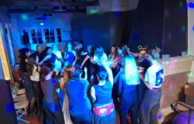 People dancing in the dark with flashing lights